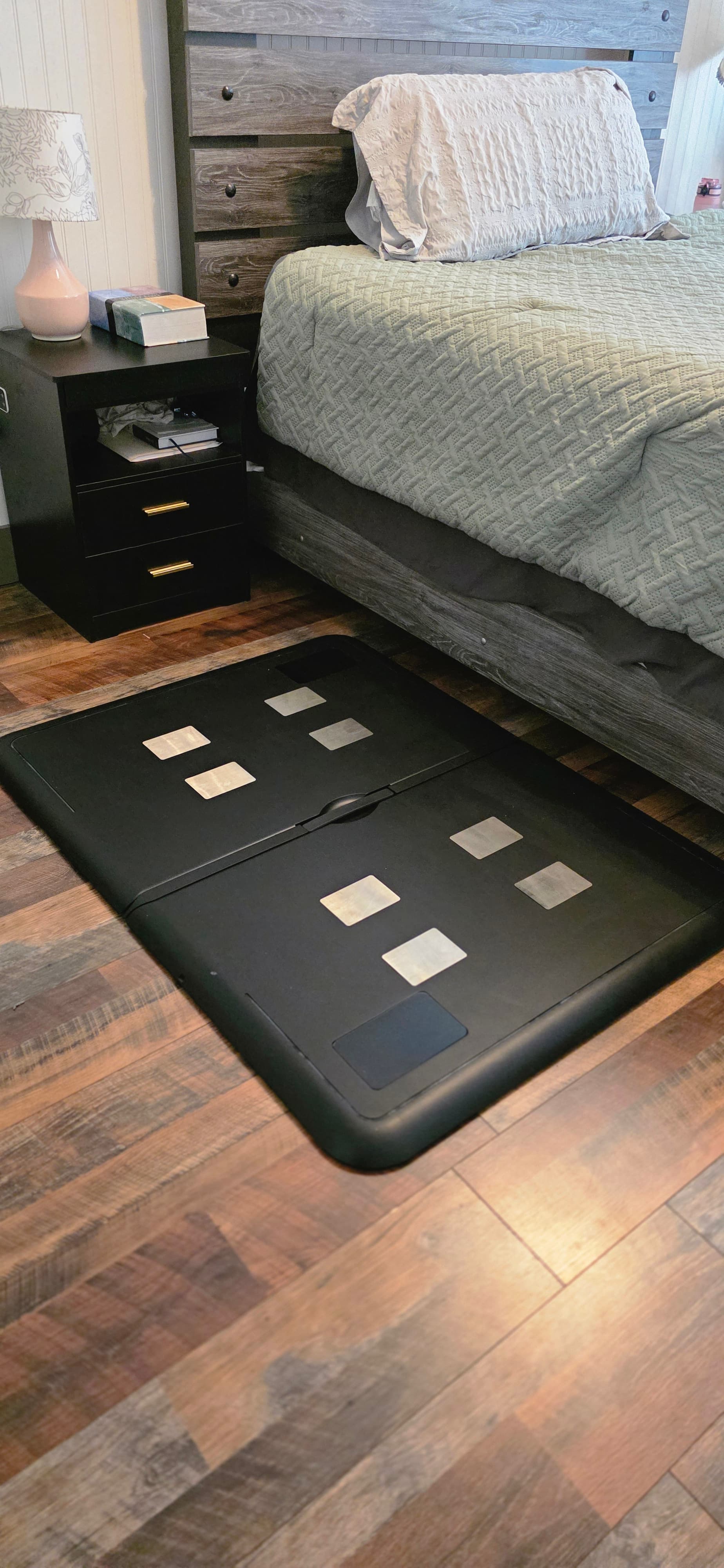 Fold health monitor unfolded beside a bed