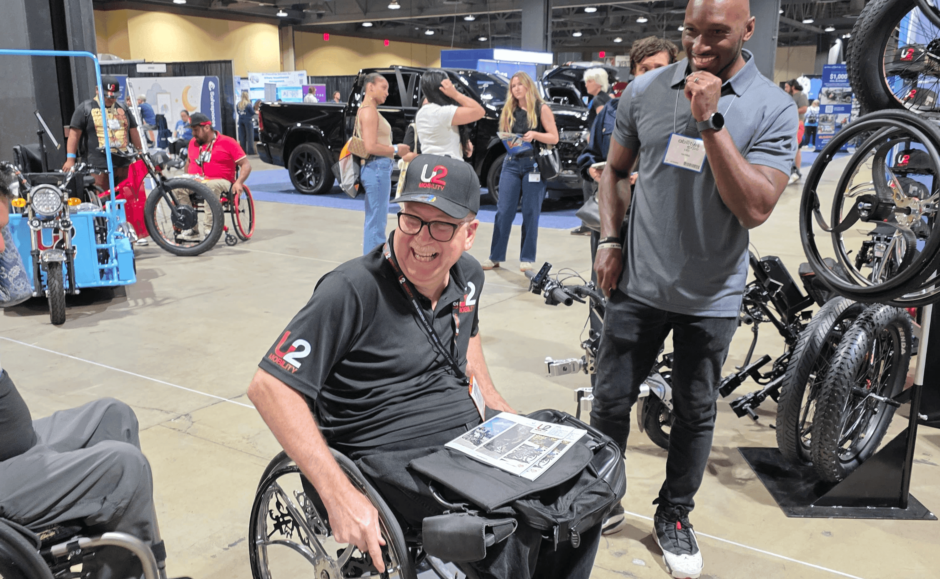 Members of the wheelchair community sharing a moment at the Abilities Expo